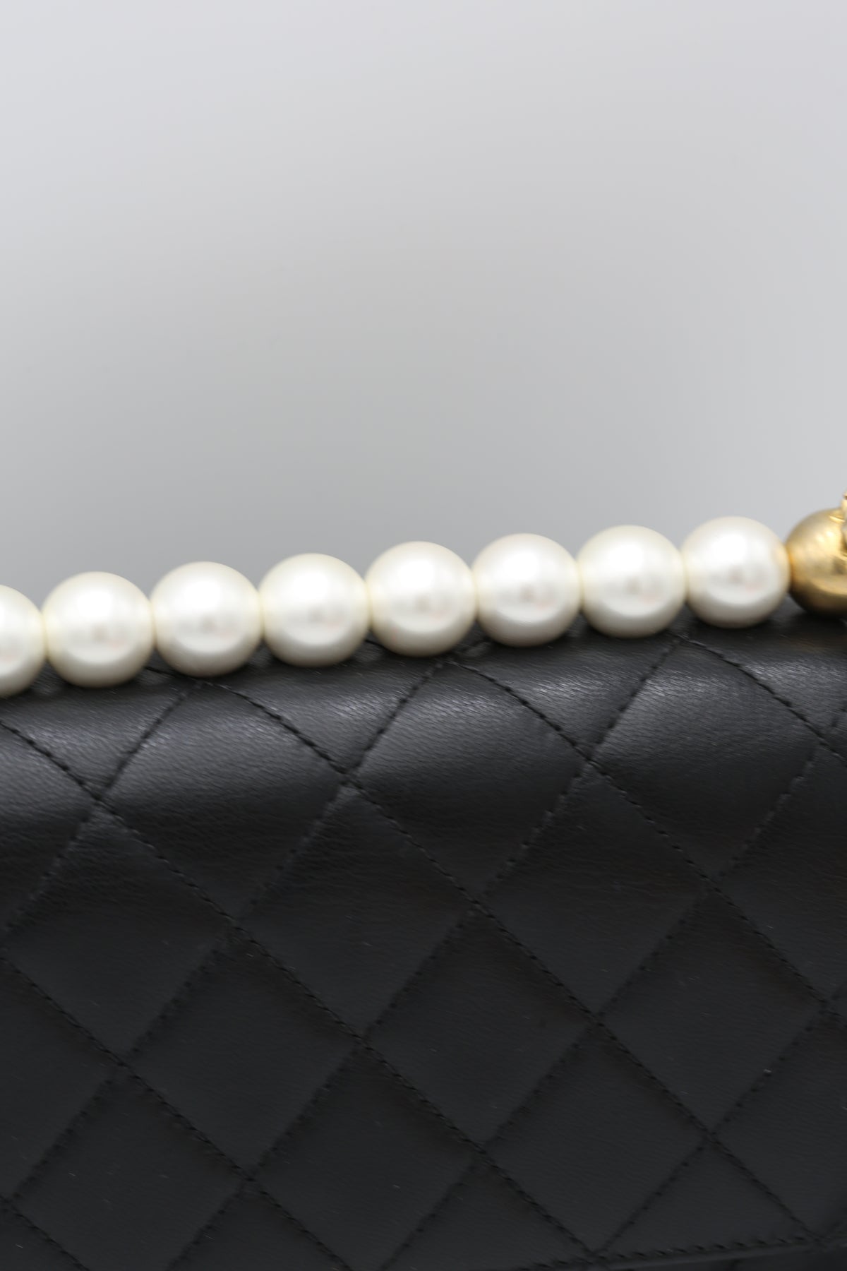 CHANEL BLACK QUILTED MINI BAG WITH PEARL HANDLE